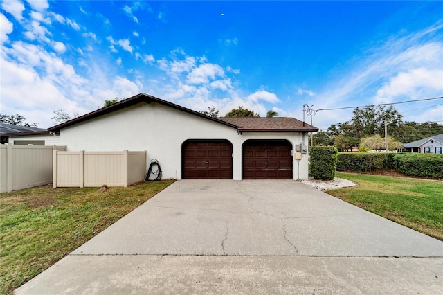 view of side of home with a lawn and a garage