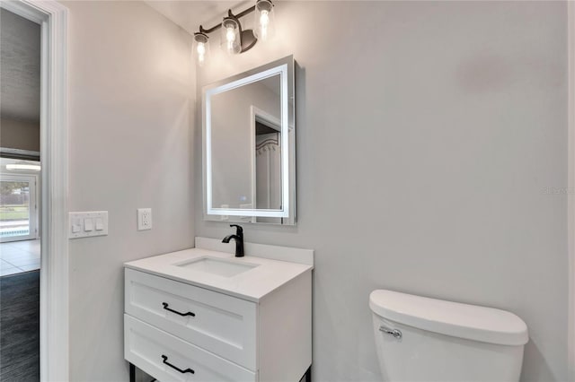 bathroom with vanity and toilet