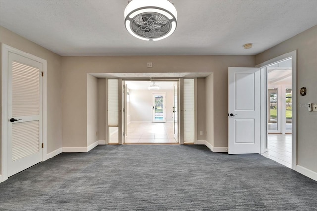 carpeted spare room featuring a textured ceiling