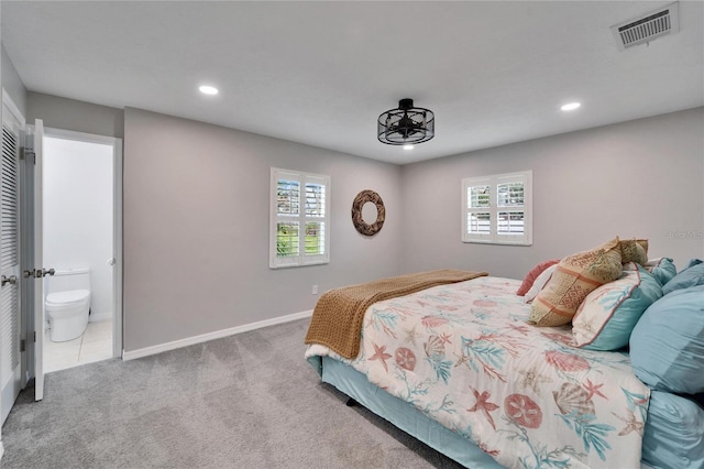 carpeted bedroom with ensuite bathroom