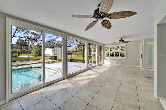 unfurnished sunroom featuring ceiling fan