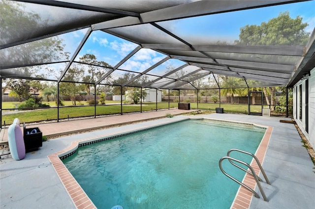 view of swimming pool with a patio area, a lanai, and a yard