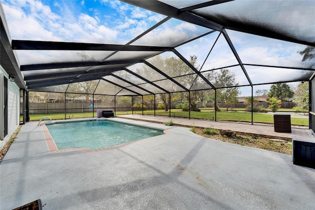 view of swimming pool with a patio area, a yard, and glass enclosure