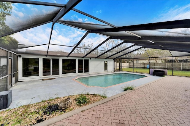 view of pool featuring glass enclosure and a patio area