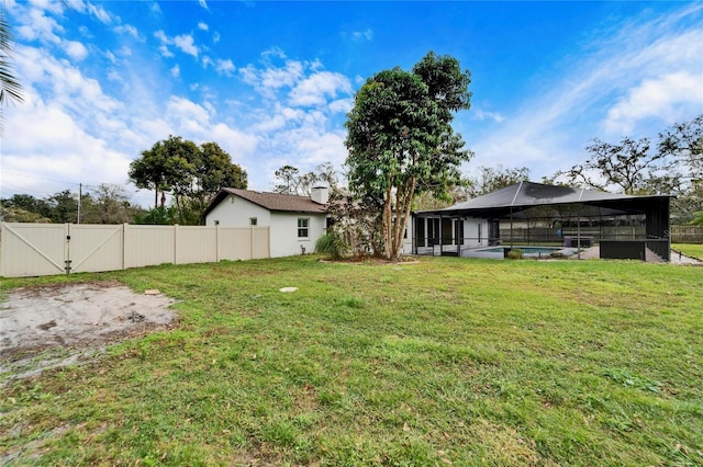 view of yard with glass enclosure and a fenced in pool