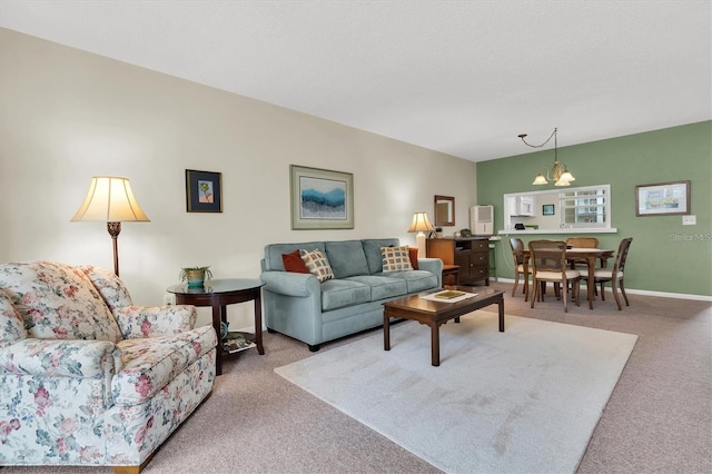 carpeted living room featuring a chandelier