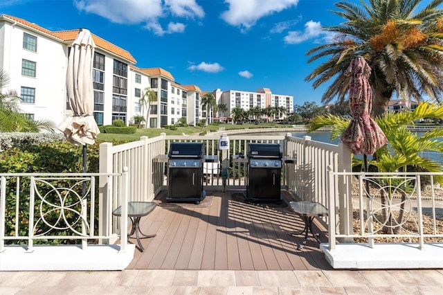 wooden deck with a grill