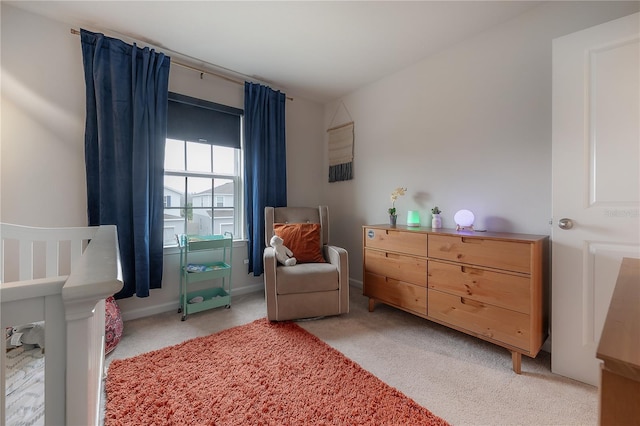 bedroom featuring carpet flooring and a nursery area