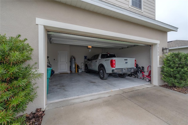 garage featuring gas water heater and a garage door opener