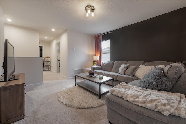 carpeted living room featuring a textured ceiling