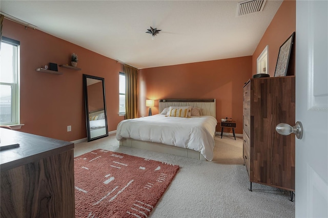 carpeted bedroom featuring multiple windows