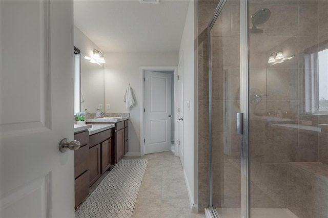 bathroom with tile patterned floors, a shower with door, and vanity