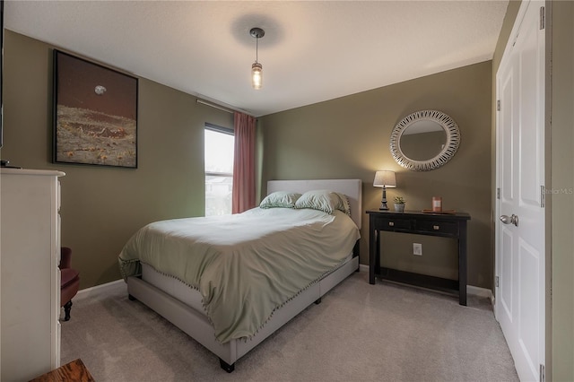 bedroom featuring light carpet