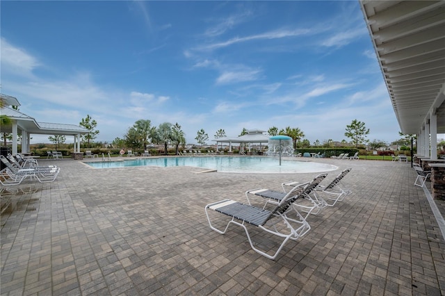 view of swimming pool with a patio area and pool water feature