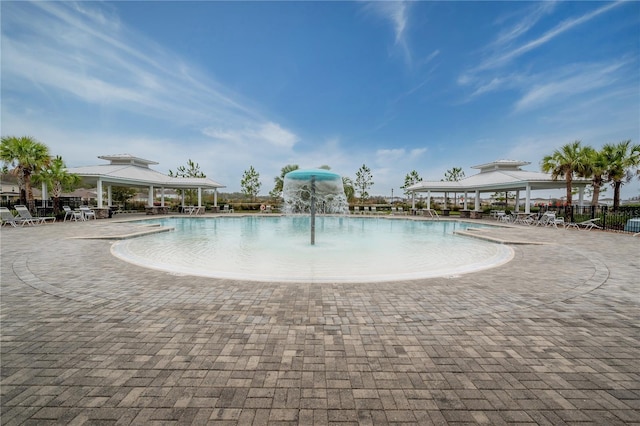 view of pool with a gazebo, a patio area, and pool water feature