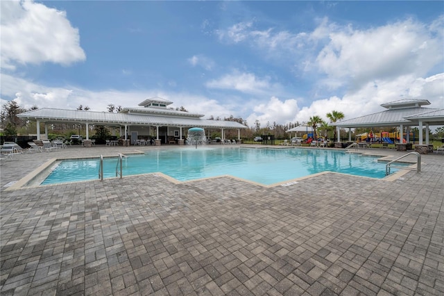 view of pool with pool water feature and a patio area