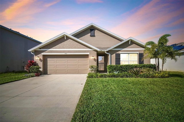 view of front of home featuring a garage and a lawn