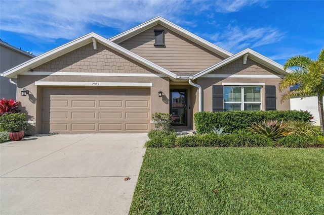 view of front of property with a garage and a front lawn