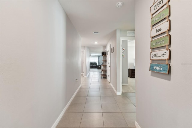 hall with light tile patterned floors