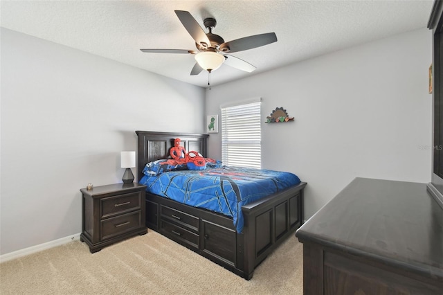 carpeted bedroom featuring a textured ceiling and ceiling fan