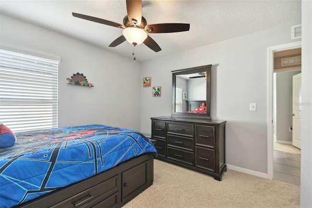 carpeted bedroom featuring multiple windows and ceiling fan