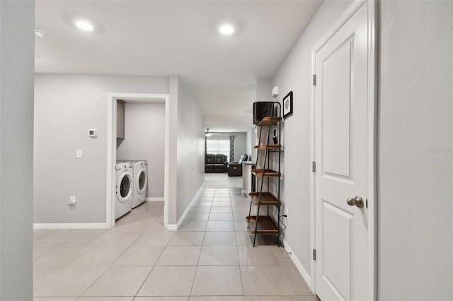 corridor with separate washer and dryer and light tile patterned flooring