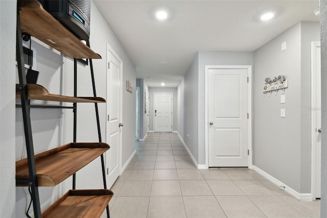 corridor with light tile patterned floors