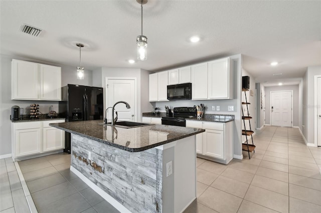 kitchen featuring sink, black appliances, a center island with sink, white cabinetry, and hanging light fixtures