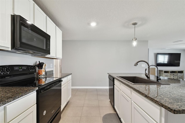 kitchen with sink, black appliances, light tile patterned floors, decorative light fixtures, and white cabinets