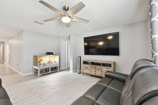 living room with light hardwood / wood-style floors and ceiling fan