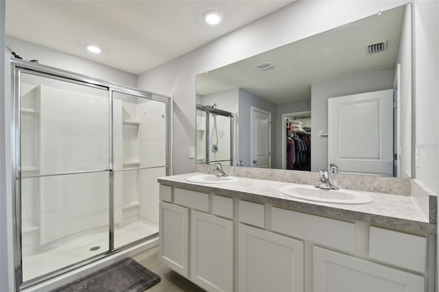 bathroom with vanity and an enclosed shower