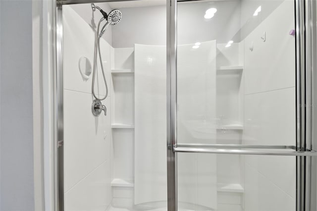 bathroom featuring a shower with shower door