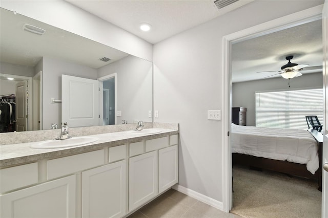 bathroom with ceiling fan, tile patterned flooring, and vanity