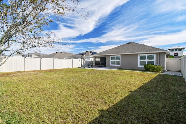 back of property featuring a yard and a patio area