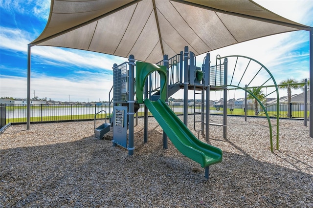 view of jungle gym featuring a water view