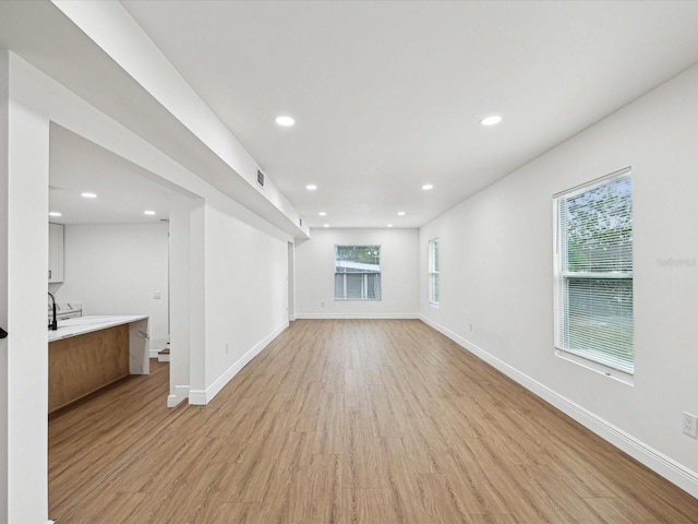 unfurnished living room featuring light hardwood / wood-style flooring