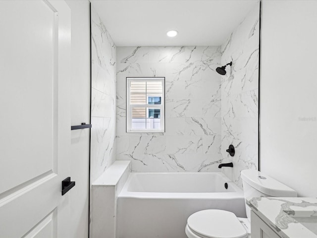 full bathroom featuring vanity, tiled shower / bath combo, and toilet