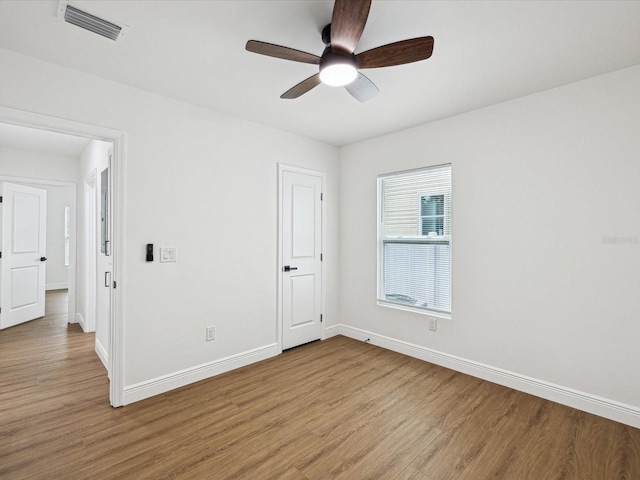 unfurnished room with ceiling fan and light hardwood / wood-style floors