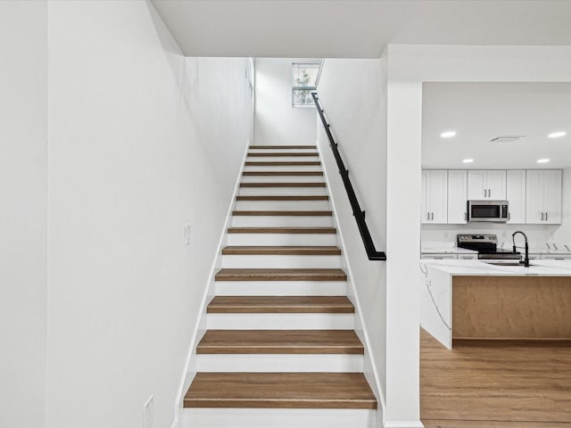 stairway featuring hardwood / wood-style flooring