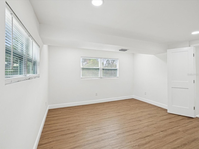 empty room with light hardwood / wood-style flooring