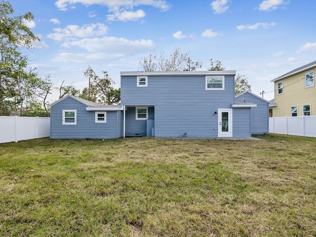 rear view of property with a lawn