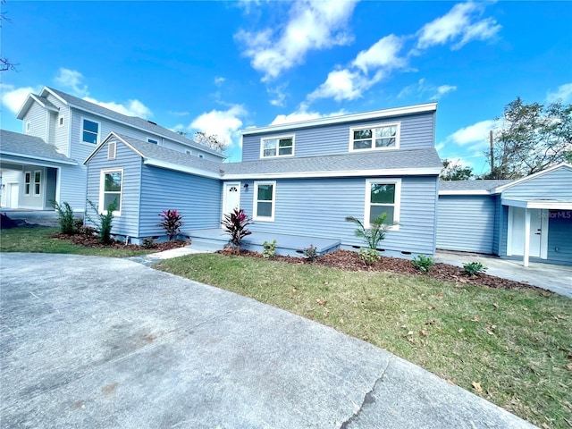 view of front property featuring a garage and a front yard