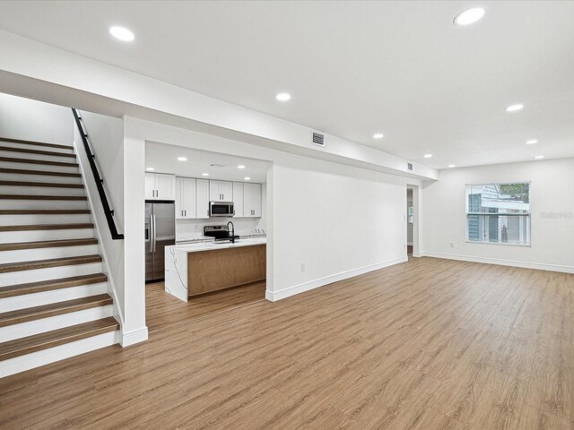 unfurnished living room with light wood-type flooring