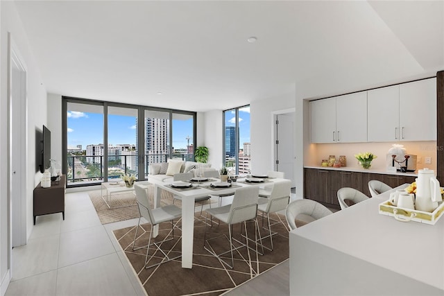 tiled dining room with a wall of windows