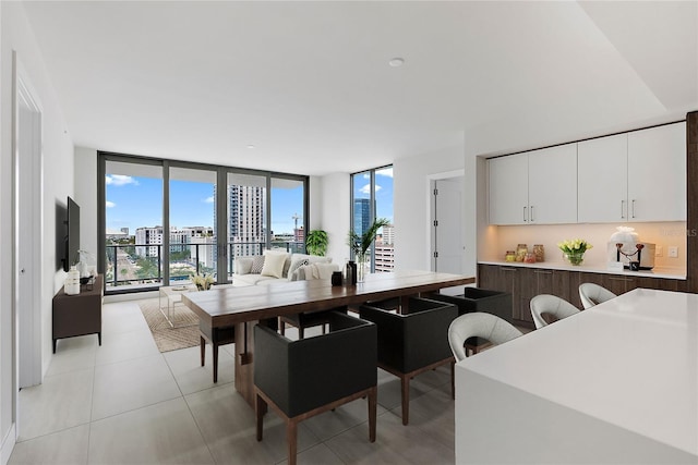 dining room featuring a wall of windows and light tile patterned floors