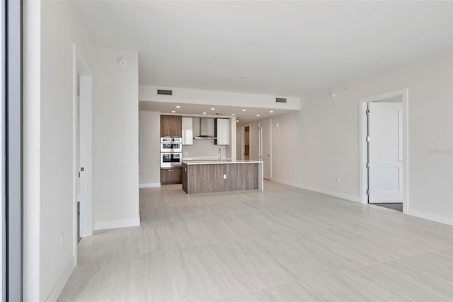 unfurnished living room with sink