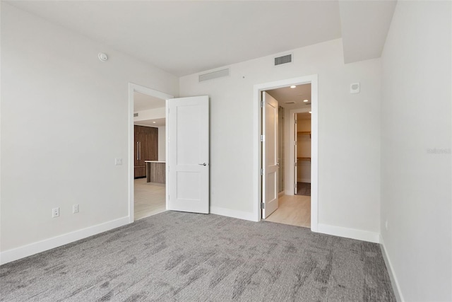 empty room featuring light colored carpet