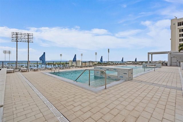 view of swimming pool with a patio