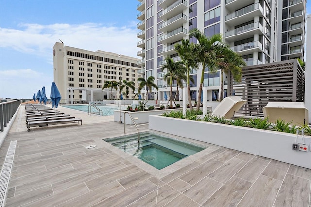 view of pool featuring a patio area and a community hot tub