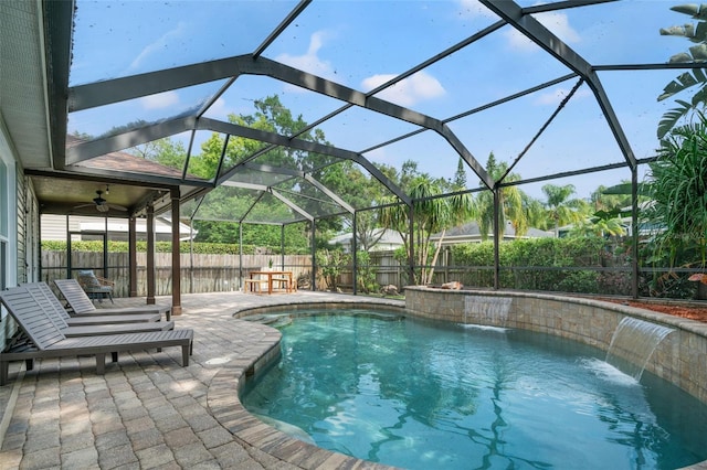 view of pool with a lanai, a patio area, pool water feature, and ceiling fan